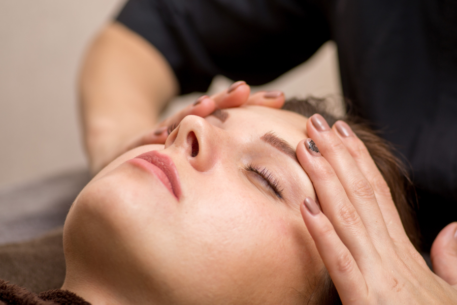 Client receiving a soothing facial lymphatic drainage massage at a med spa in Richmond Hill.